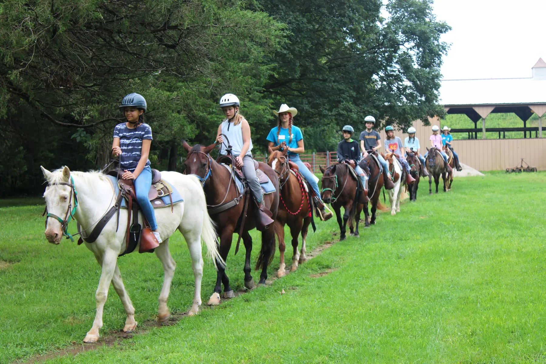 campers at ymca camp lakewood equestrian camp riding horses on trail