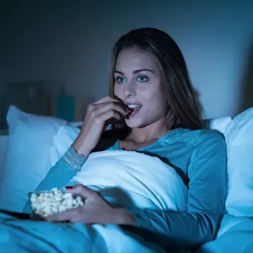 woman eating in bed