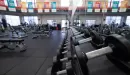 Thumbnail: An image of the row of dumbbells leaning against the mirrored-wall at the Monroe County YMCA. The walking and running track is also visible in the background of the image. 