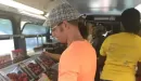 Thumbnail: An image of Caucasian and African American male and female volunteers on the YMCA's food bus.