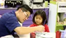 Thumbnail: Father and daughter painting in arts & crafts