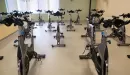 Thumbnail: Cycling room with spin bikes placed throughout room. 
