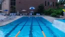 Thumbnail: Three outdoor lap lanes. Small waterfall from adjacent pool flowing into one lane. Lounge chairs on side of lap lanes.