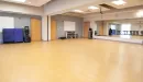 Thumbnail: Group exercise room with mirrors on one side. Large, rectangular room with non-slip flooring.