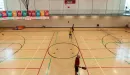 Thumbnail: One-Court gymnasium with lines for basketball, volleyball, and pickleball. Multiple baskeball hoops on either side of gym. Indoor track running overhead.