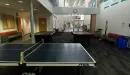 Thumbnail: Community area with ping pong table and pool tables. Seating areas on two walls.