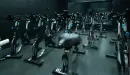 Thumbnail: Cycling room with spin bikes placed throughout room. Dark painted walls.