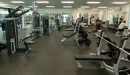 Thumbnail: Weight room featuring benches, machines, free weights, and squat racks throughout room.