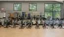 Thumbnail: Group exercise studio with spin bikes along wall. Large windows and mirrors throughout room.