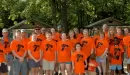Thumbnail: Alums in orange shirts