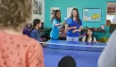 Thumbnail: ymca y club staff plays ping pong with y club participants