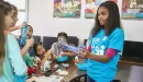 Thumbnail: kids and y club staff have fun with a science experiement