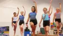 Thumbnail: a group of girls show off their balance skills in a ymca gymnastics class