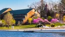 Thumbnail: scene of lodge and lake with redbuds blooming