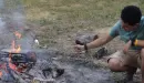 Thumbnail: boy toasting marshmallows over a campfire
