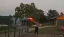 Thumbnail: a female counselor shooting an arrow on fire across the lake