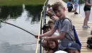 Thumbnail: young campers fishing on bridgeway