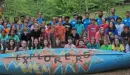 Thumbnail: Large group of explorer campers posed by canoe