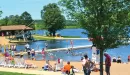Thumbnail: Colorful scene of people enjoying the lake and sandy beach