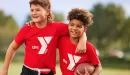 Thumbnail: ymca youth flag football participants embrace in friendship
