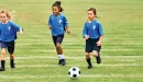 Thumbnail: ymca youth soccer participants dribble a soccer ball down the field