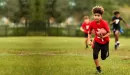 Thumbnail: ymca youth flag football participant runs down field