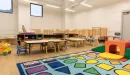 Thumbnail: The Bayer Early Childhood Education Center Main Room with Cribs