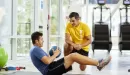 Thumbnail: man working out with medicine ball with personal trainer