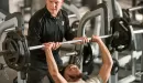 Thumbnail: man lifting weights with ymca employee