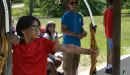 Thumbnail: A boy shooting bow and arrow while others watch