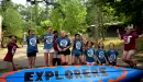 Thumbnail: ymca camp lakewood explorers girls jumping by canoe
