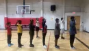 Thumbnail: boys in BYMOC in the gym holding up their fists as a salute