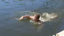 Thumbnail: A boy swimming near the dock