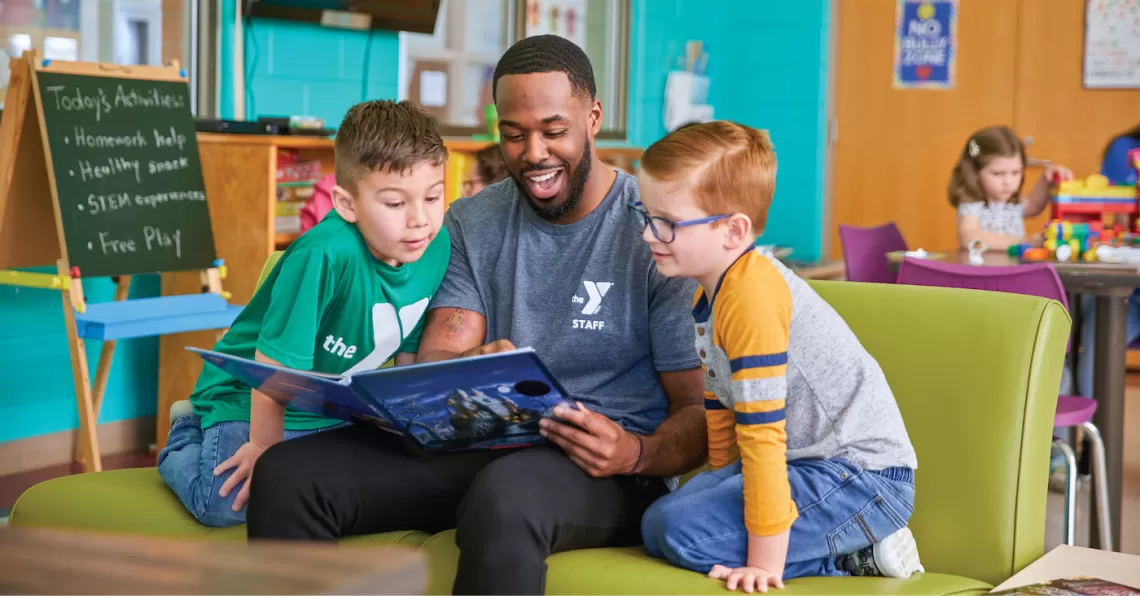 YMCA Y Club Before & After School Program Participants Reading a Book in a School Classroom