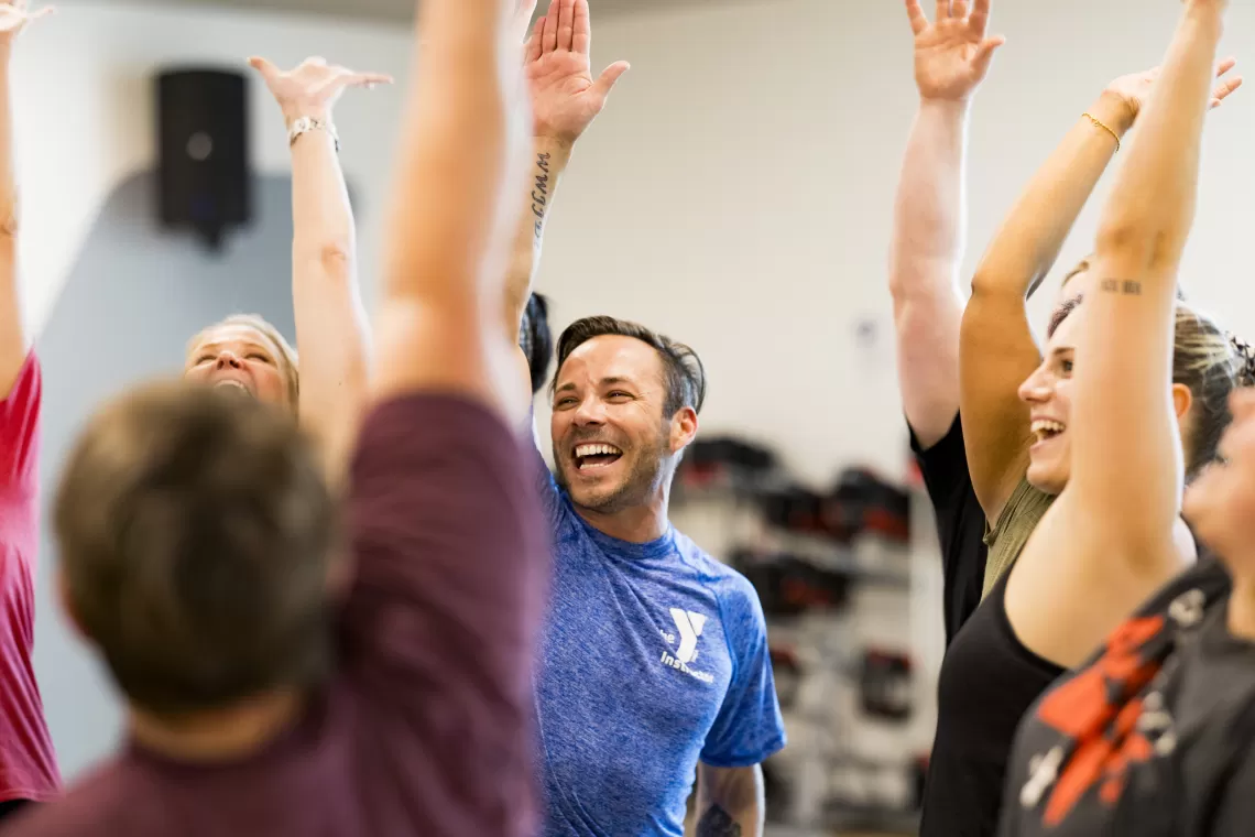 YMCA Group Exercise class participants celebrating the completion of a LesMills BODYPUMP class.