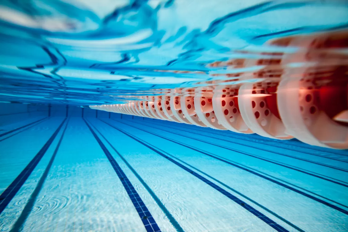 Indoor swimming pool showing lap lanes and clear water