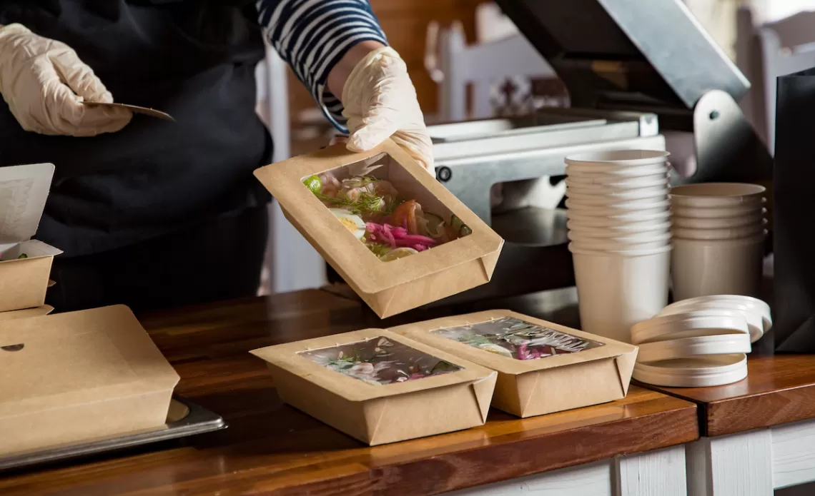 boxed meals being prepared for a corporate retreat group's catered lunch