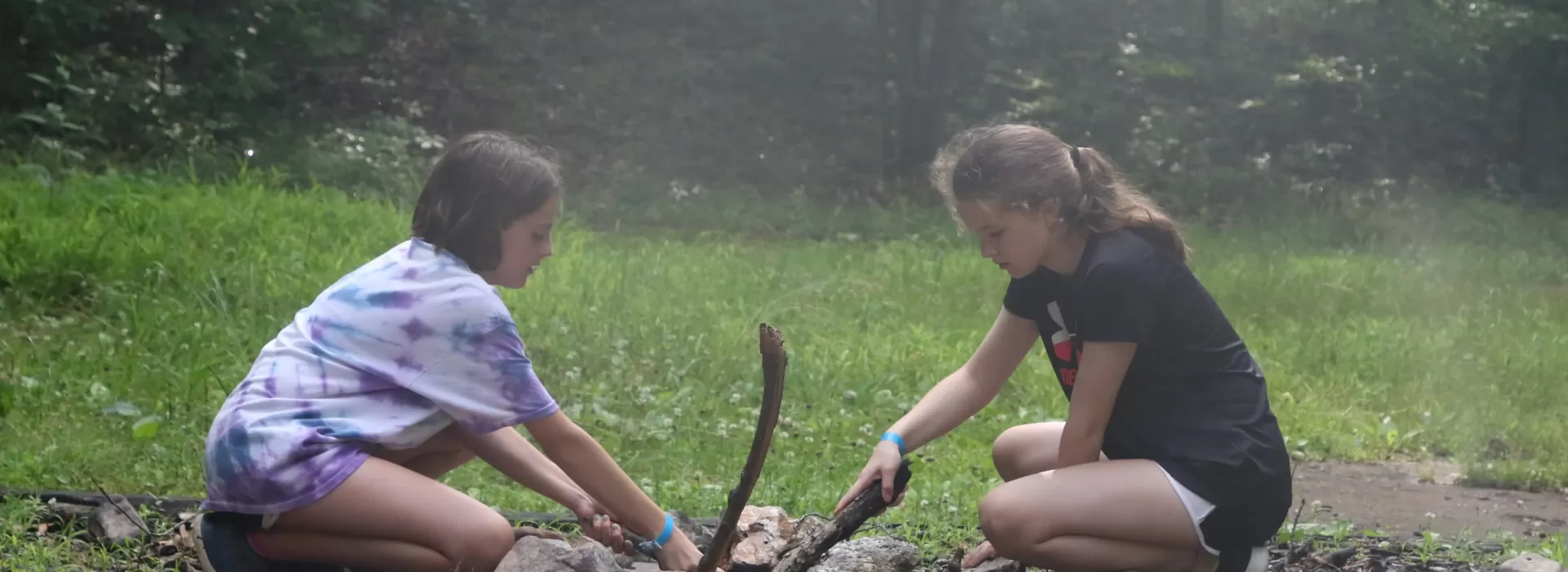 Campers building a fire at Camp Lakewood