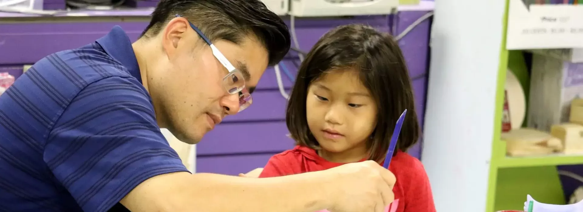 Father and daughter painting in arts &amp; crafts