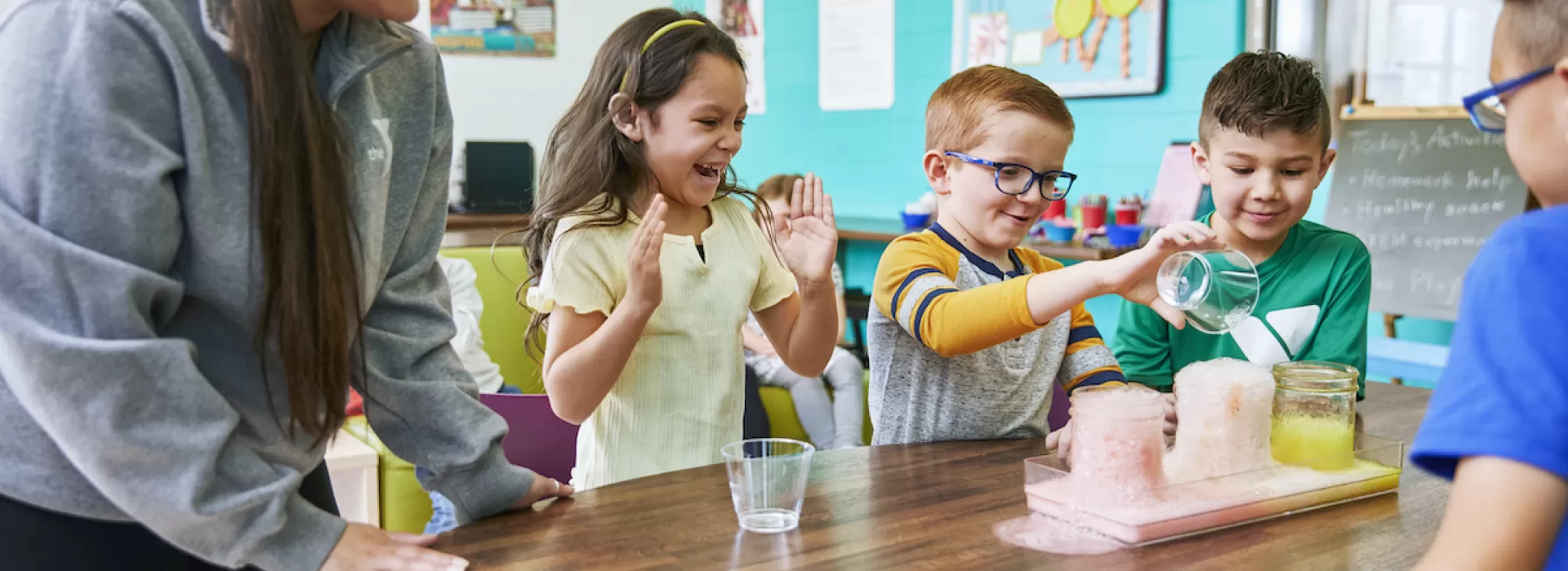 y club staff doing a science experiment with y club participants