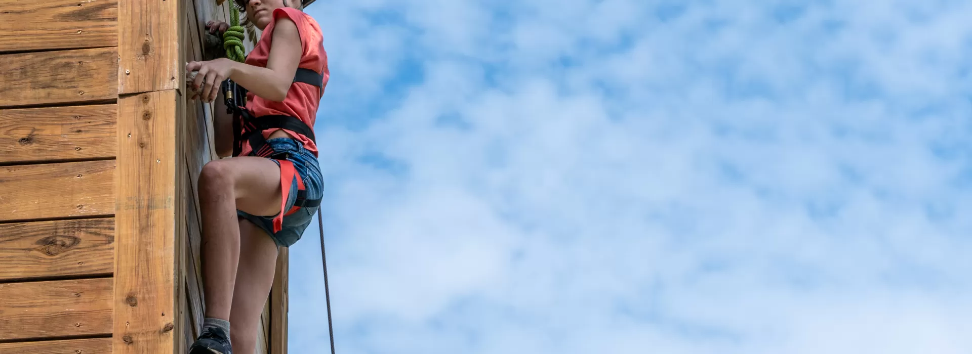 girl climbing tower and bright blue sky