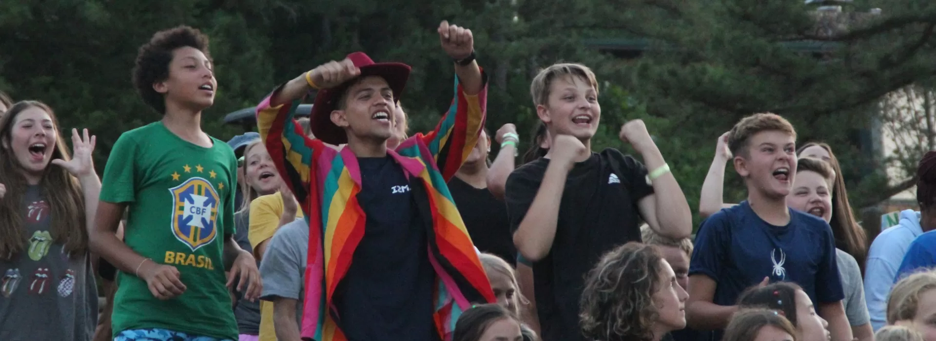 boys cheering at campfire