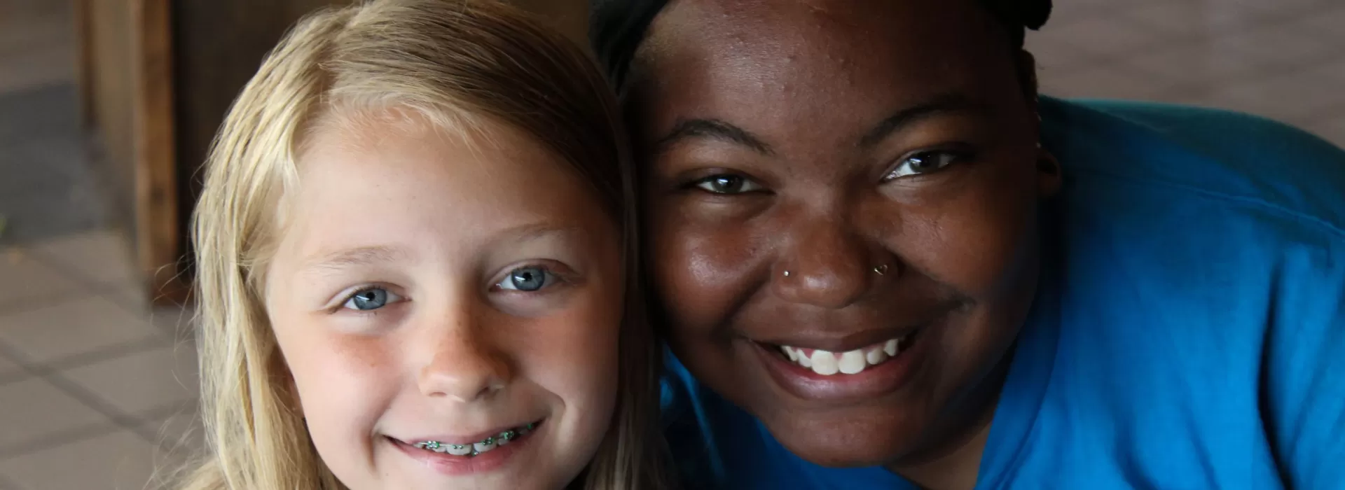 Smiling camper and camp staff