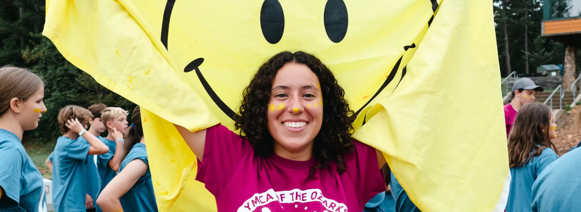 Smiling staff female with big yellow smiley face