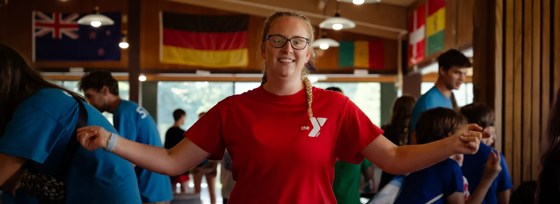 Happy staff member indoors with others