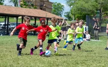 Young soccer players compete in a friendly match wearing newly branded CITY SC and Gateway Region YMCA jerseys.